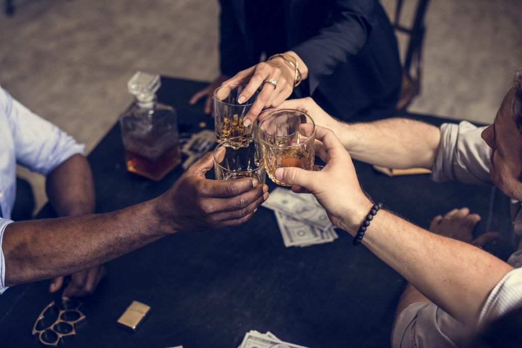 Hand toasting an alcohol together