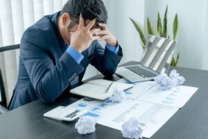Businessman acted with tired stress anxiety from the frustrated business crisis